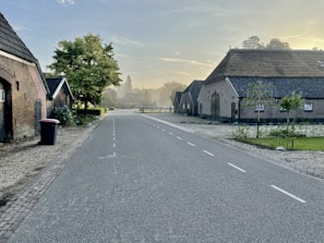 A quiet countryside bathed in the deep reds of early morning light.
