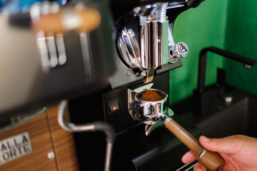 person pouring coffee on coffee cup