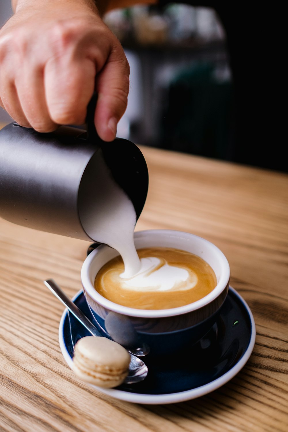 person pouring coffee on white ceramic mug