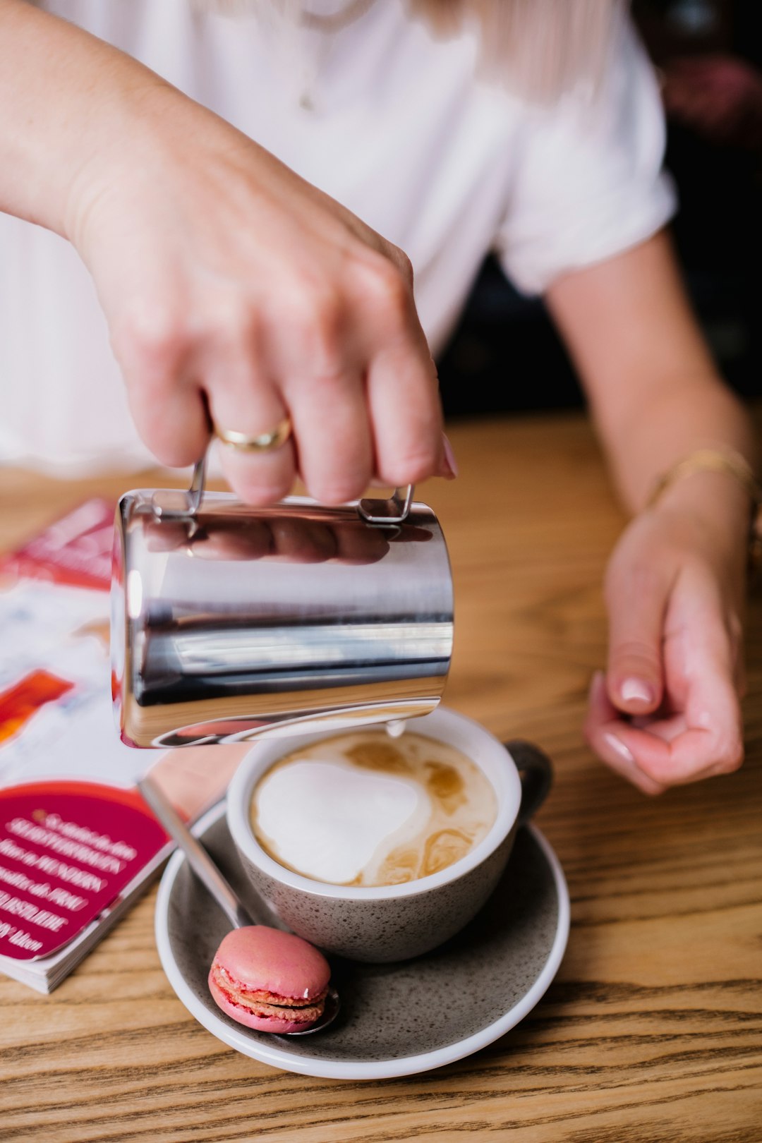 person holding stainless steel cup with coffee