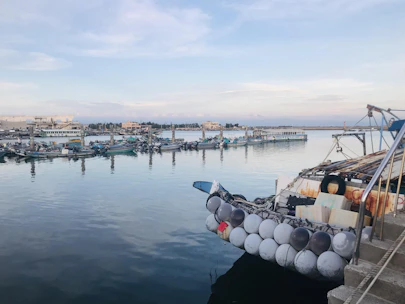 Close-up of durable rubber fenders installed on a busy harbor pier.