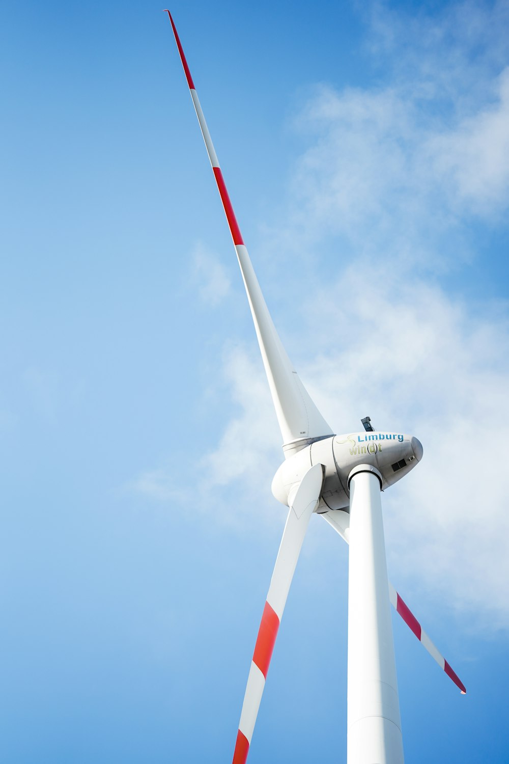 a wind turbine with a blue sky in the background