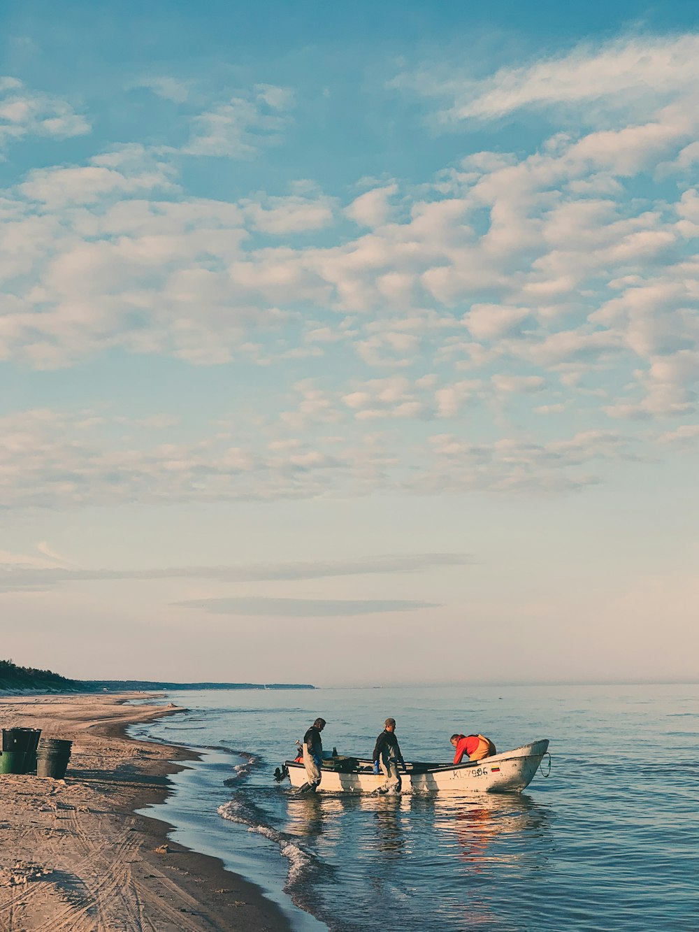 two people in a small boat on the beach