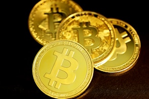 a group of gold bitcoins sitting on top of a table