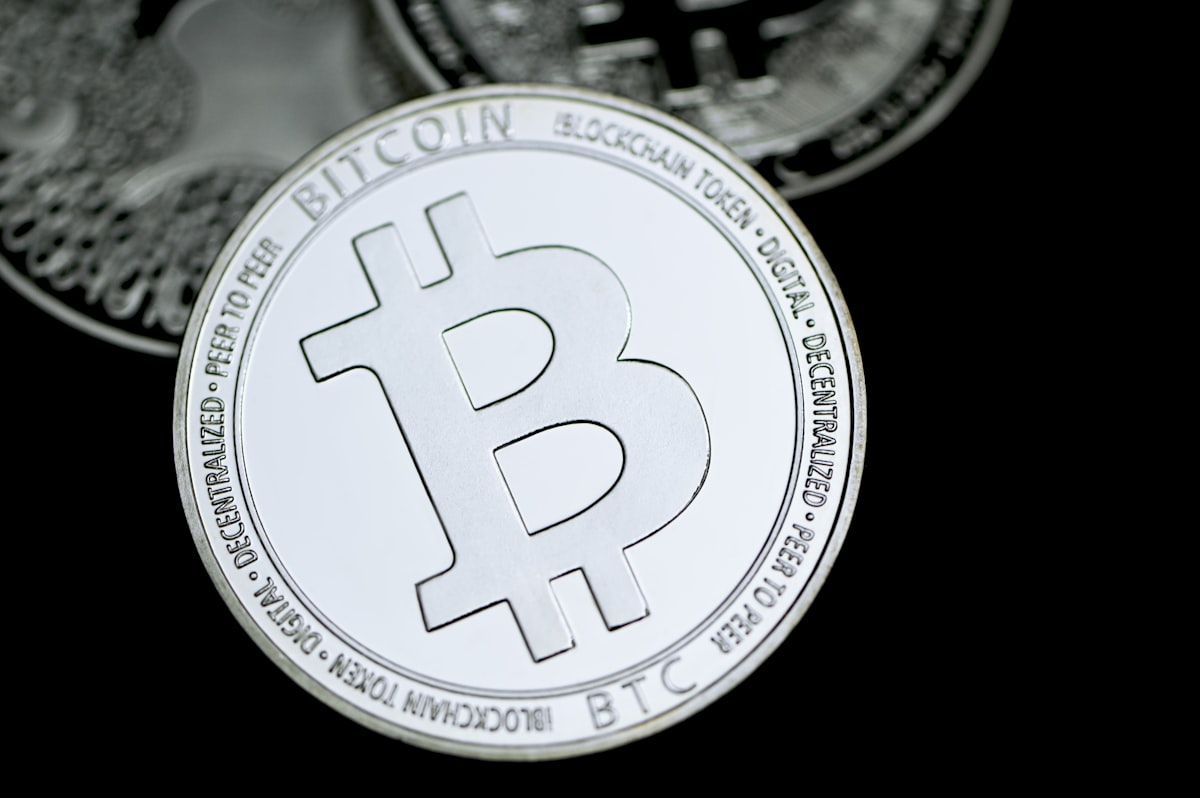 Close-up of a silver Bitcoin coin on a dark background