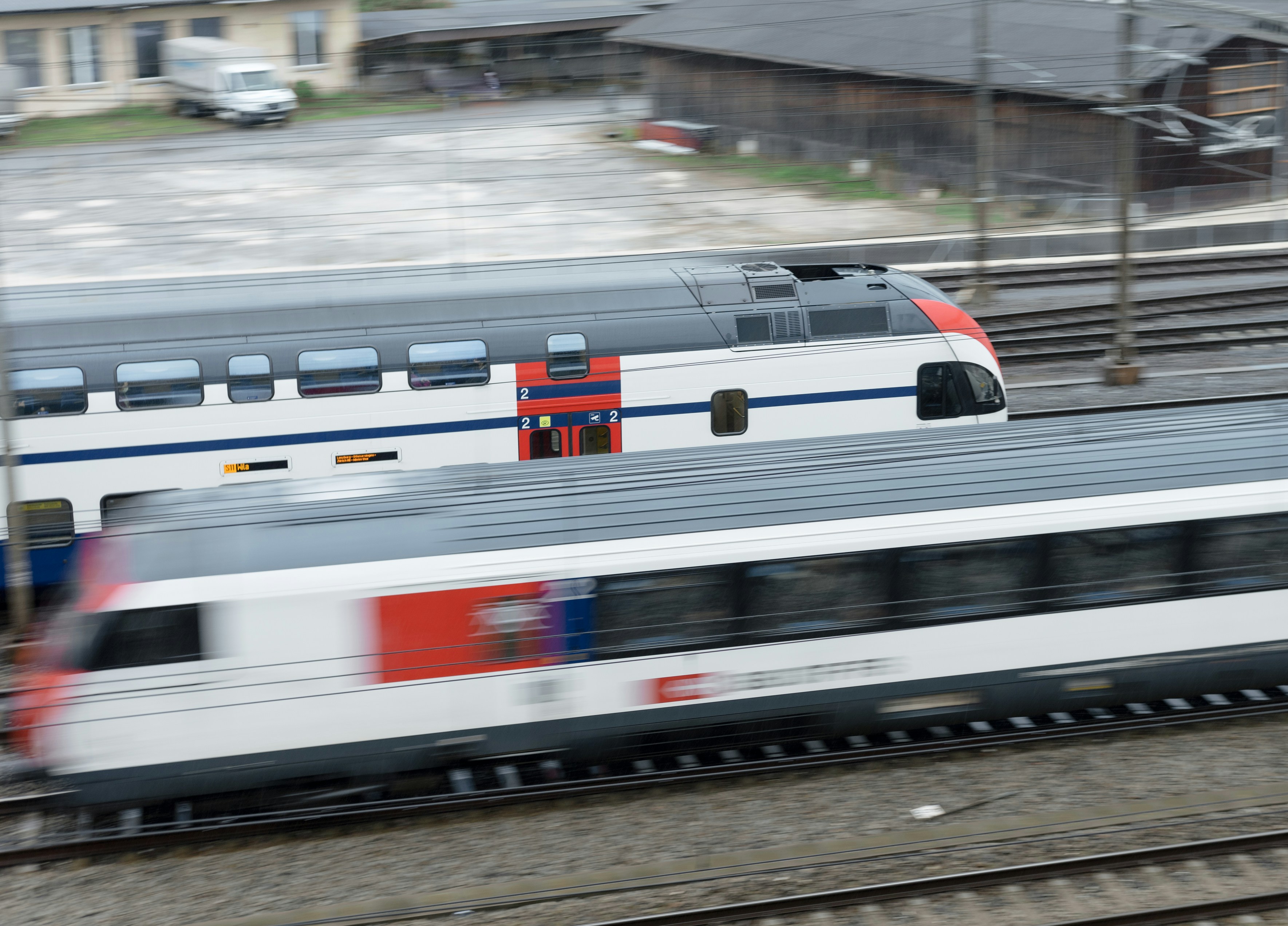 a train traveling down train tracks next to a building