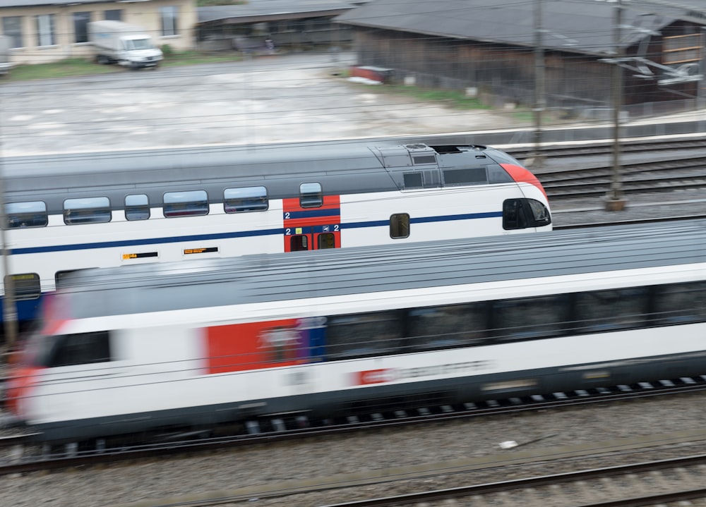 a train traveling down train tracks next to a building