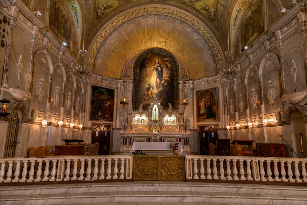 the interior of a church with a large painting on the wall