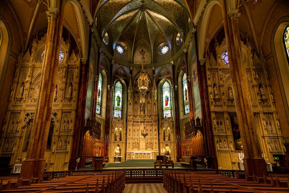 a cathedral with stained glass windows and pews