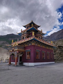 a red building with a yellow and blue roof