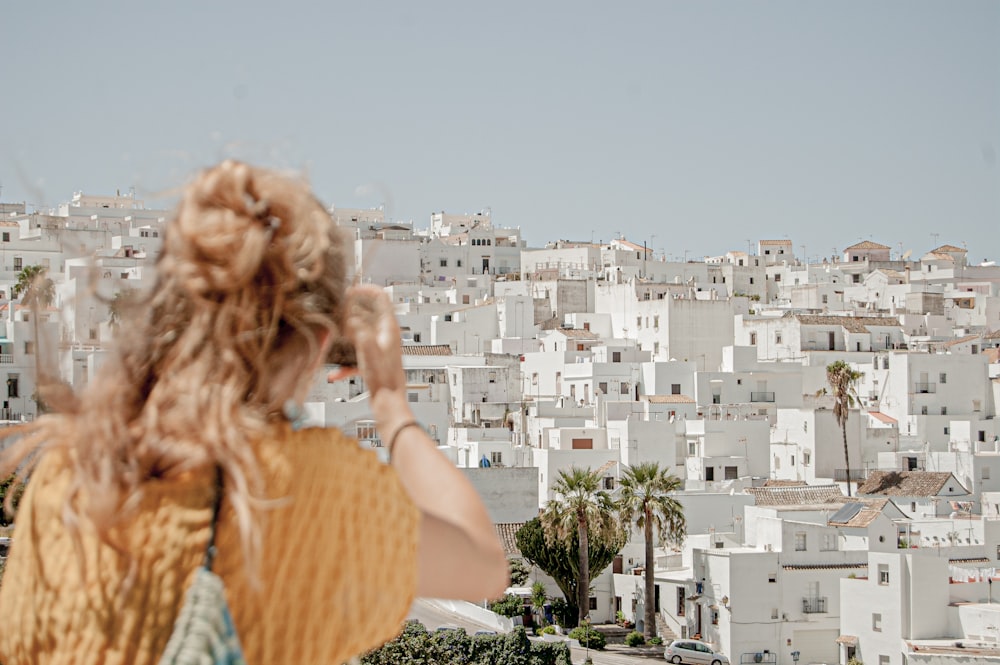 a woman standing in front of a city skyline