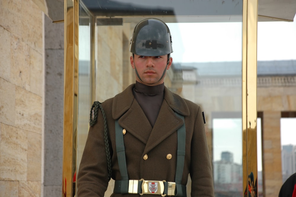 a man in a military uniform standing in front of a building