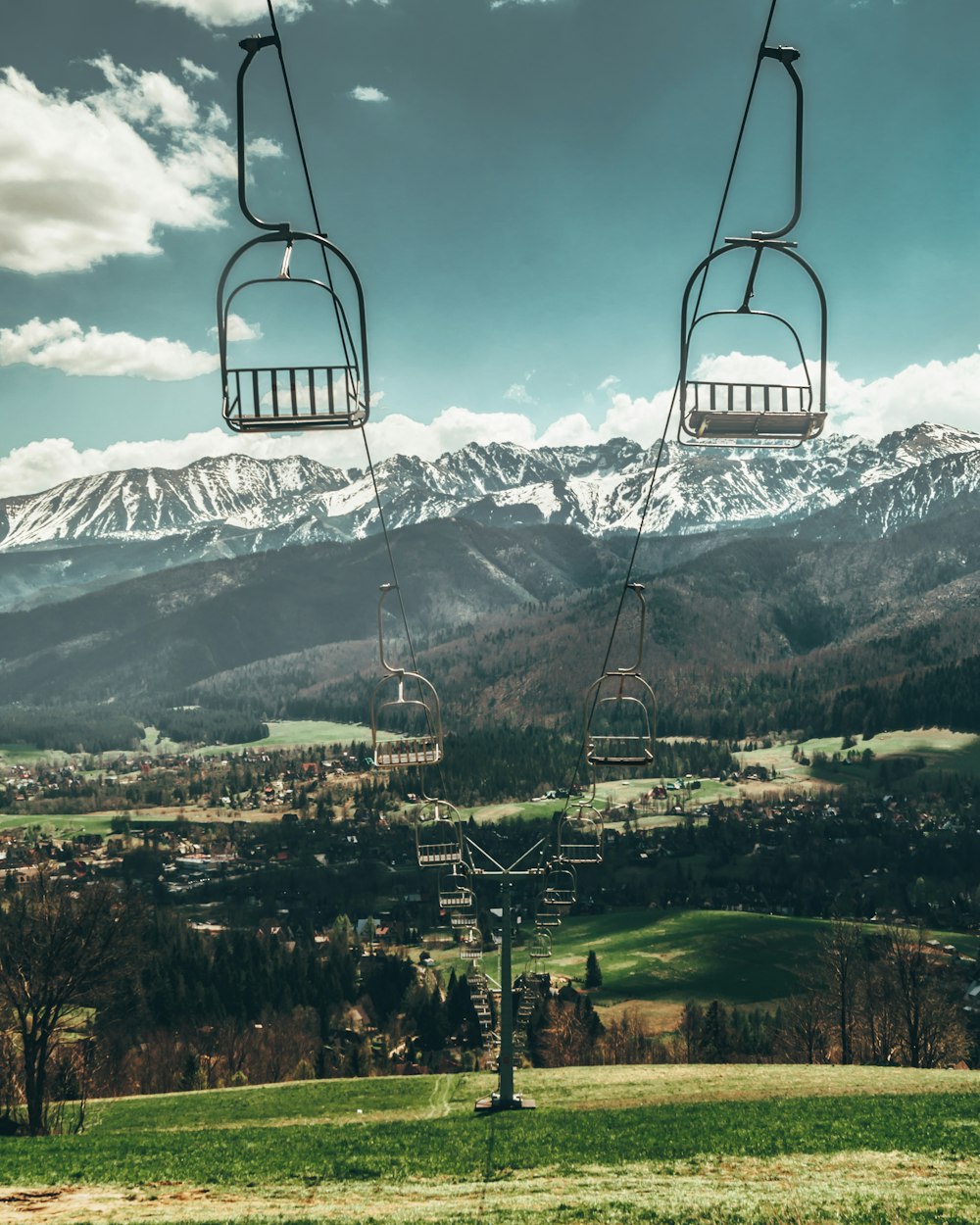 a couple of ski lifts going up a hill