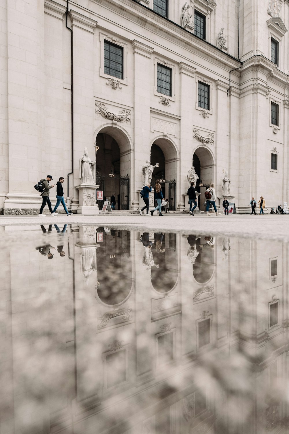 a group of people walking in front of a building