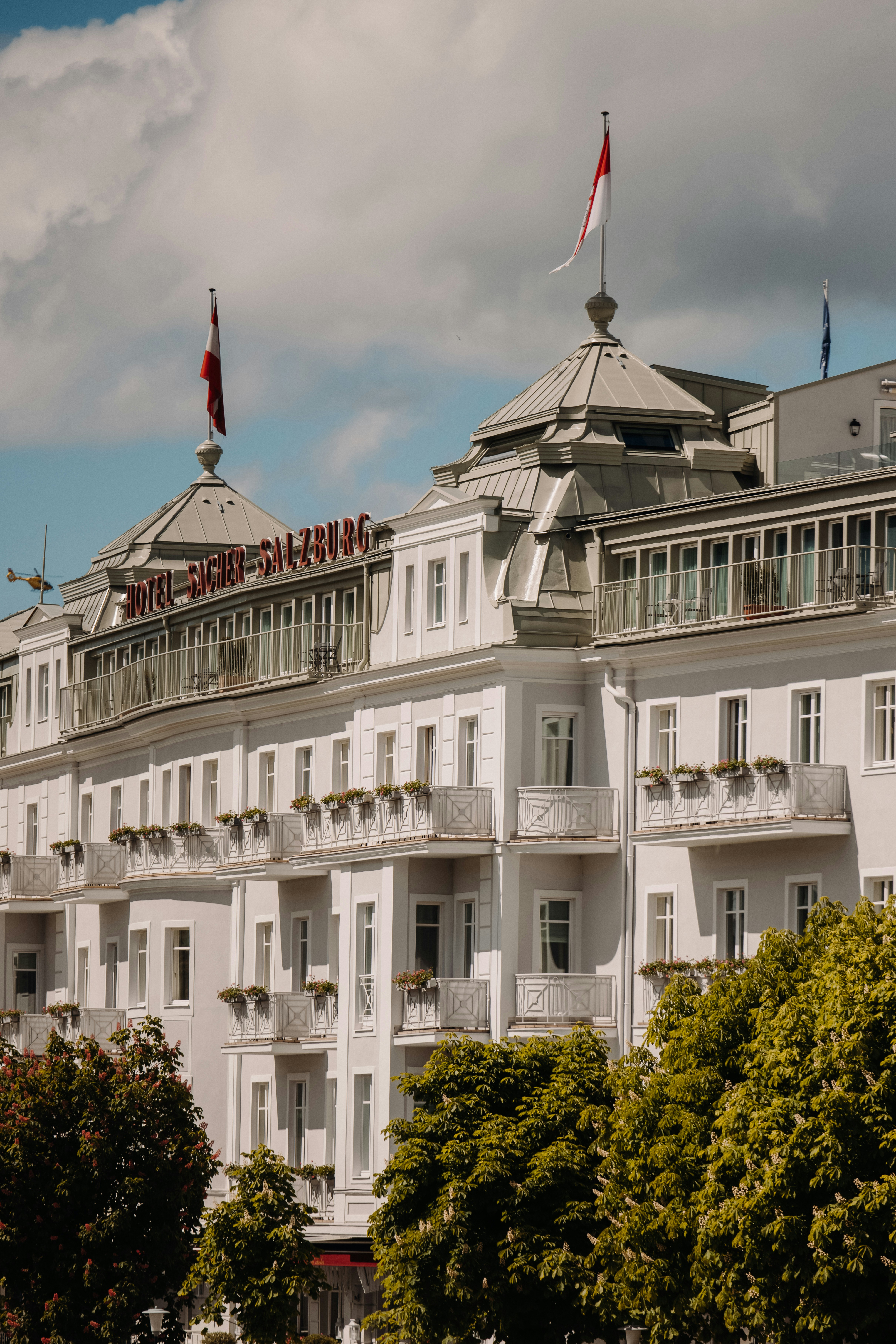 a large white building with a flag on top of it