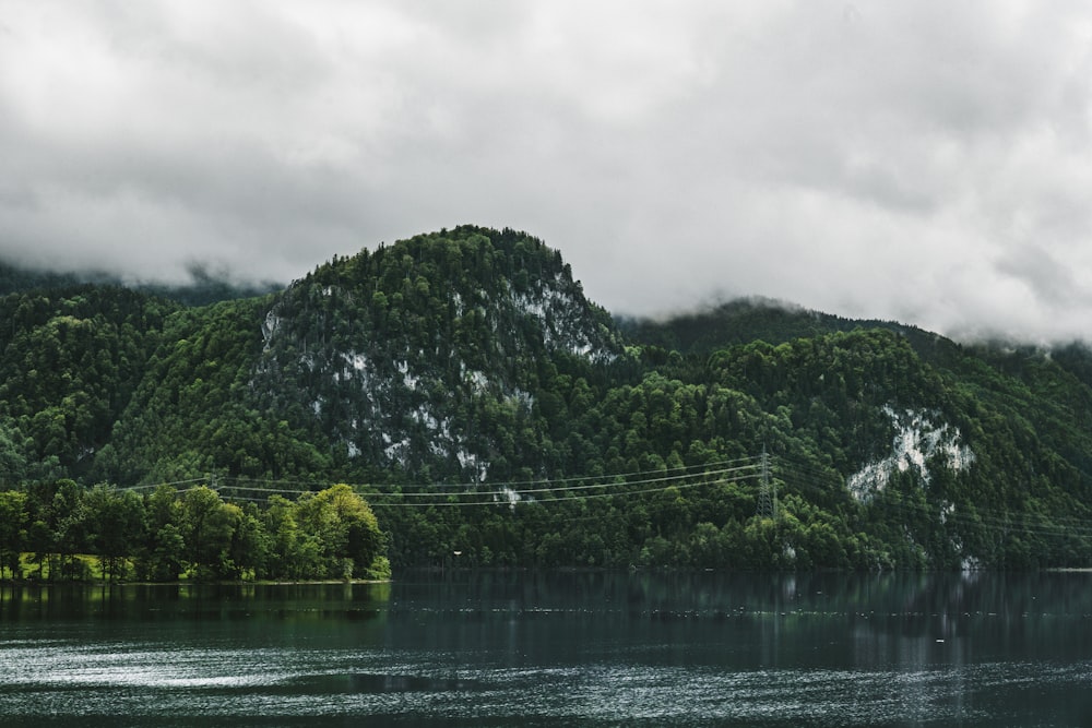 a body of water with a mountain in the background