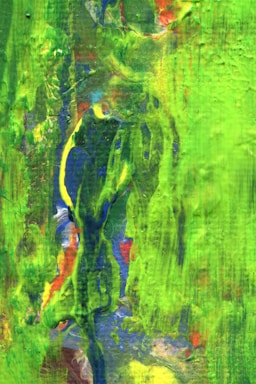 Vivid, abstract painting with broad strokes of bright green dominating the scene. Hints of blue, yellow, red, and white create a dynamic, layered look, with textured effects and flowing forms.