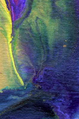 An abstract painting with vibrant blues and greens swirling together.