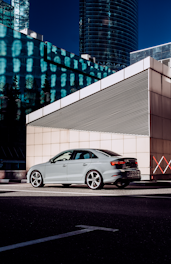 a silver car parked in front of a building
