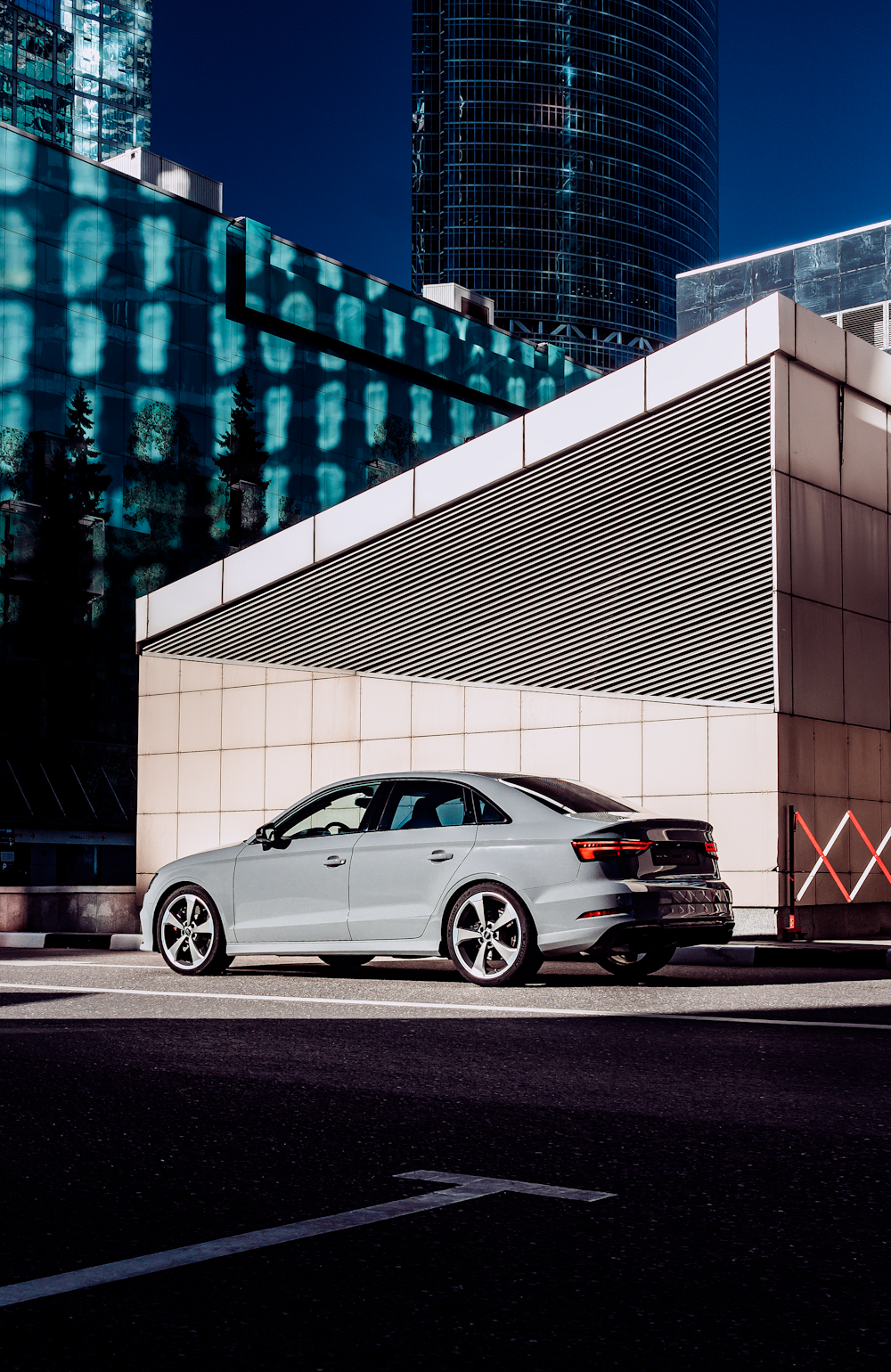 a silver car parked in front of a building