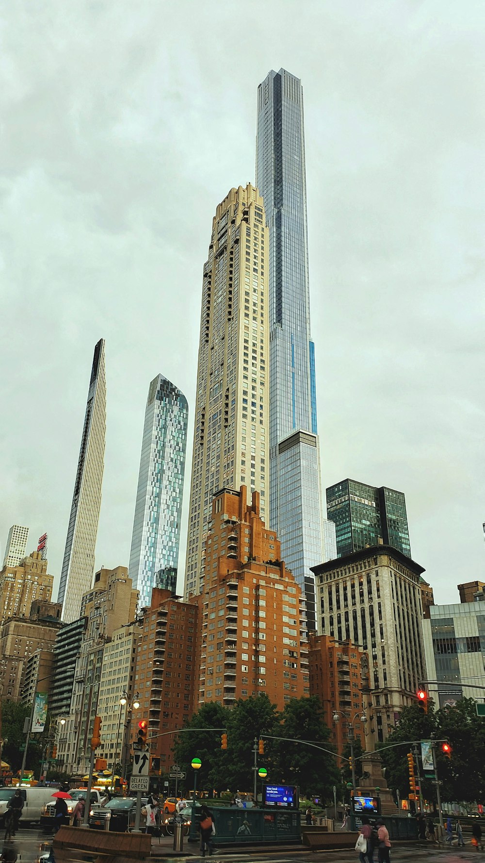 a group of people crossing a street in front of tall buildings