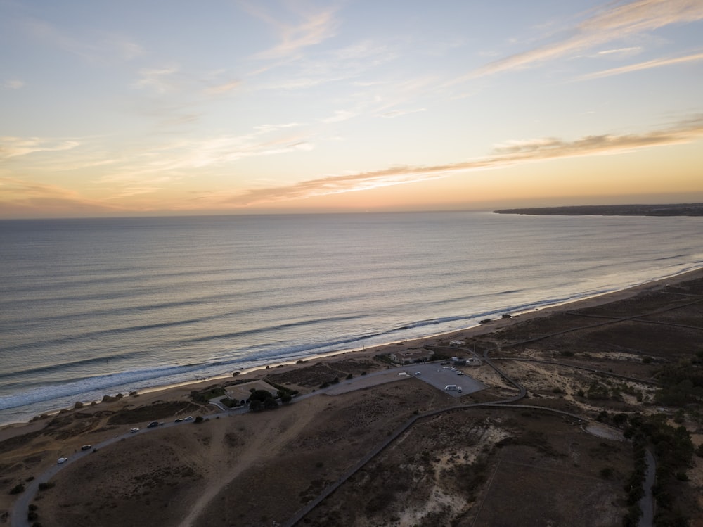 an aerial view of a beach at sunset