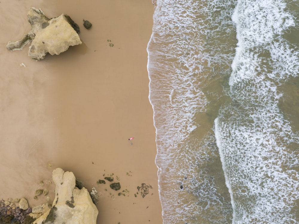 an aerial view of a sandy beach and ocean