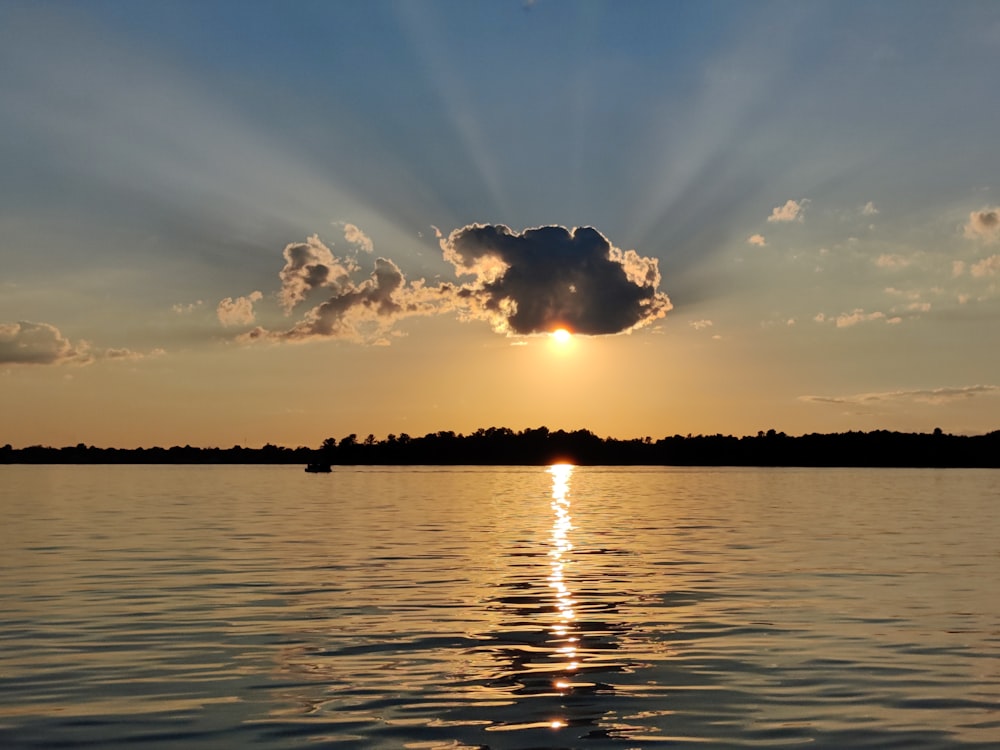 the sun is setting over a body of water