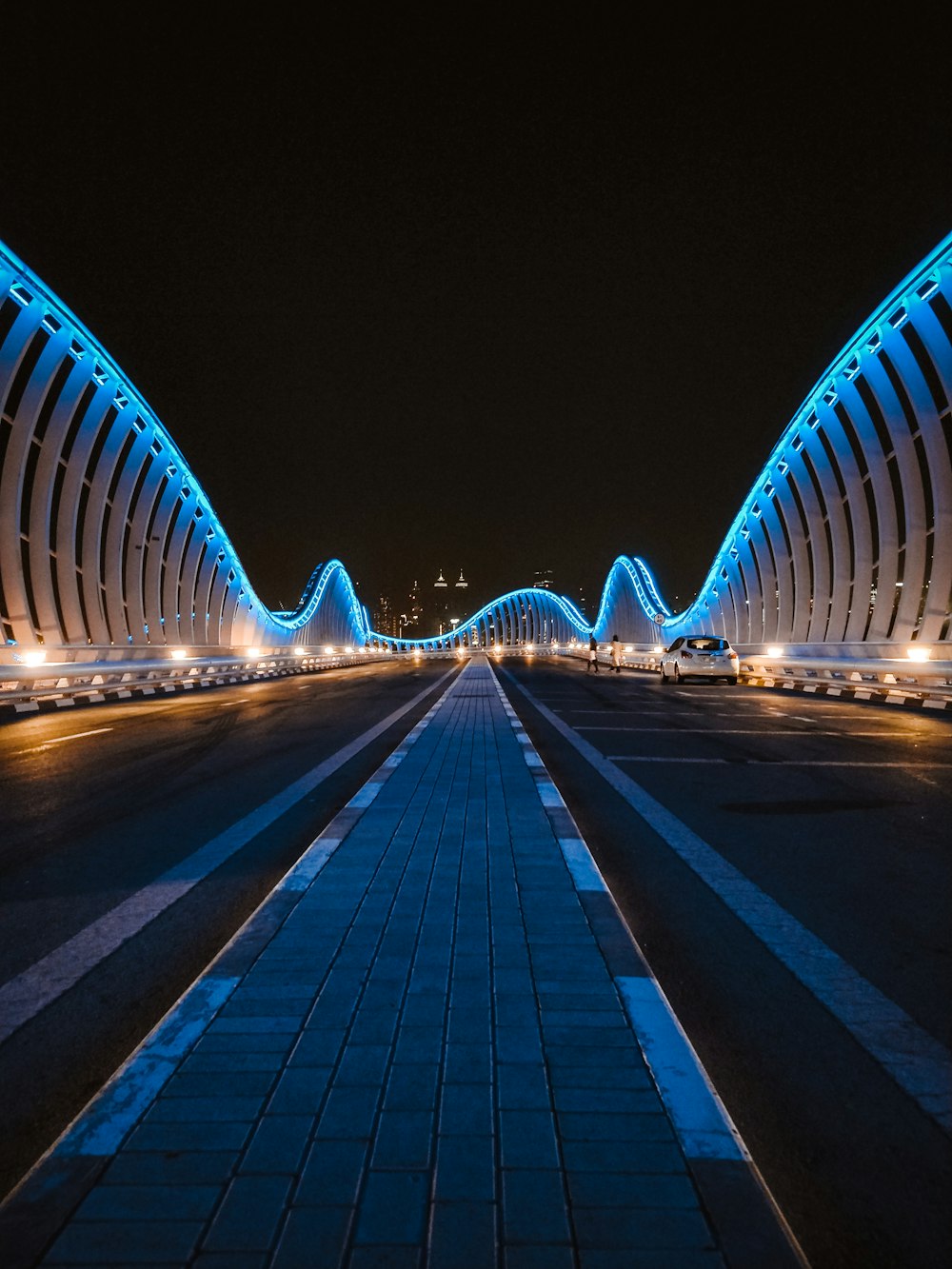 a very long bridge that is lit up at night
