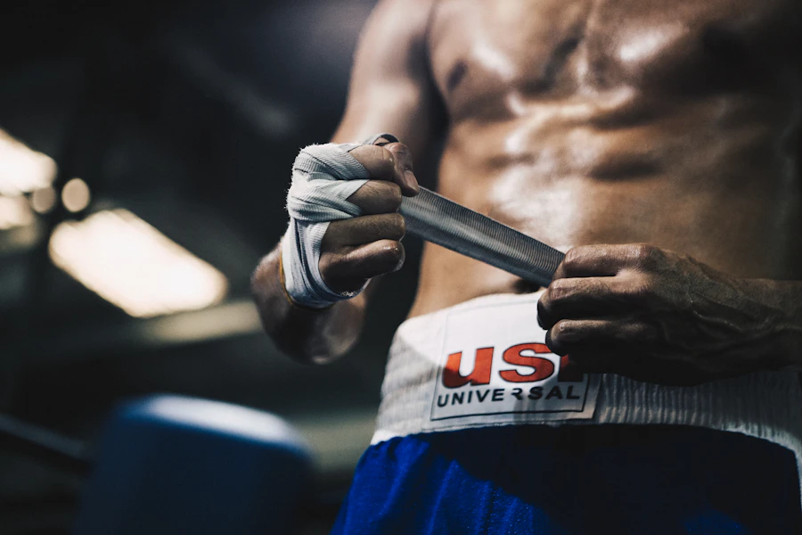 A boxer taping their hands before training