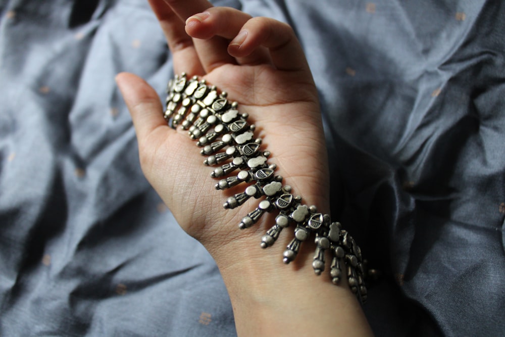 a woman's hand with a bracelet on it