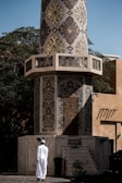 a man standing in front of a tall tower