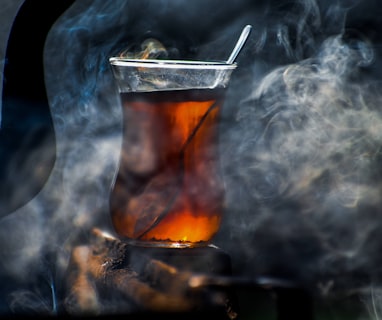 a glass filled with liquid sitting on top of a table