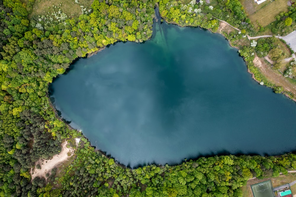 an aerial view of a lake surrounded by trees