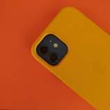 A smartphone showing an email marketing campaign with vibrant orange highlights.