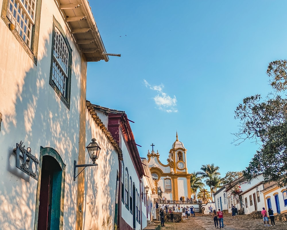 a group of people walking down a cobblestone street