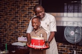 man in white button up shirt holding red and silver drum