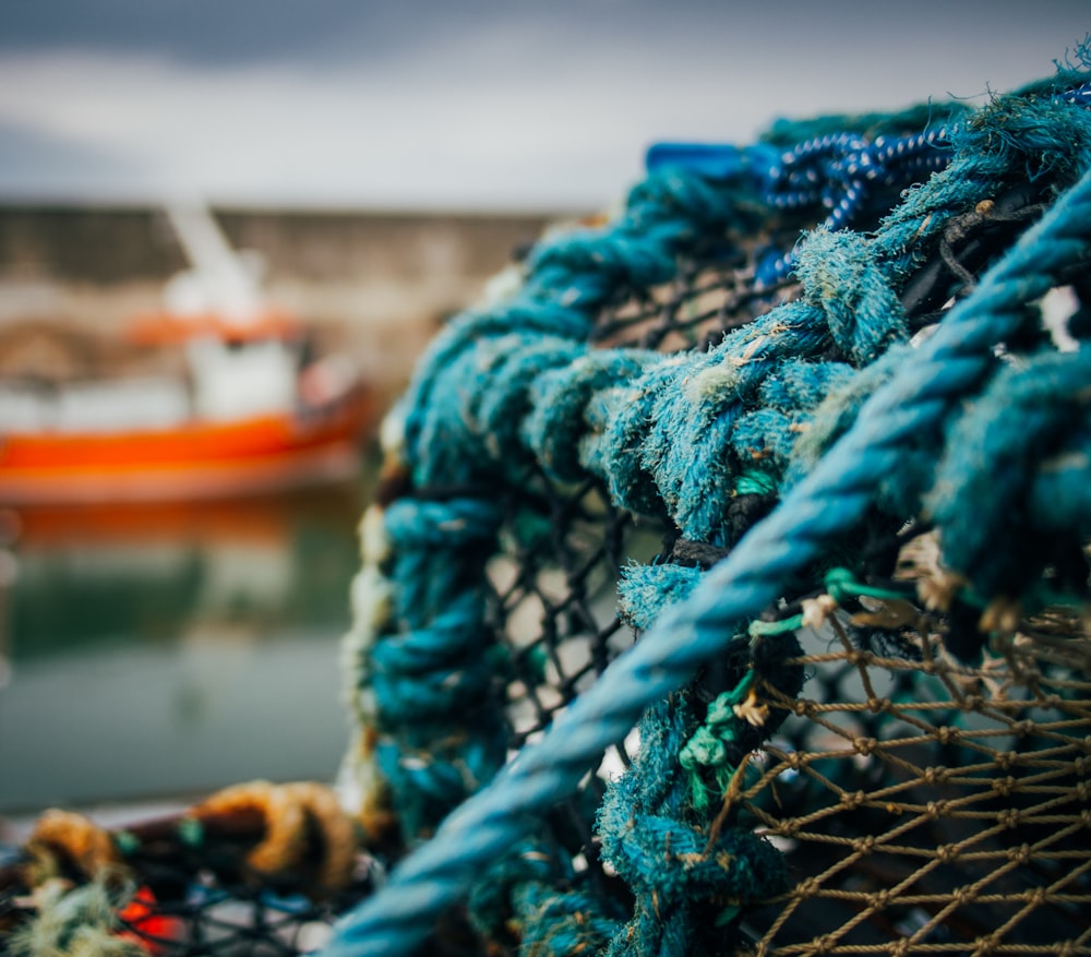 a fishing net with a boat in the background