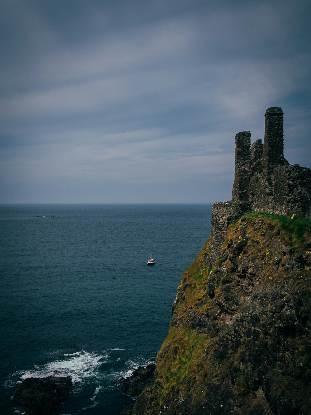 a boat is out on the water near a castle