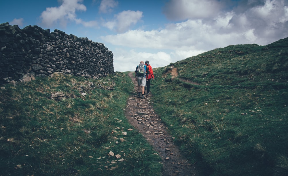 a couple of people that are walking down a hill