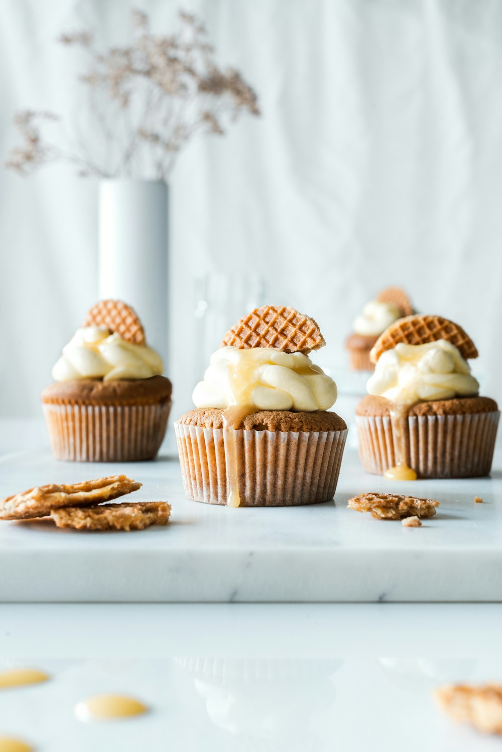 una mesa cubierta con cupcakes cubiertos de glaseado