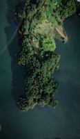 an aerial view of a lake with a rainbow in the sky