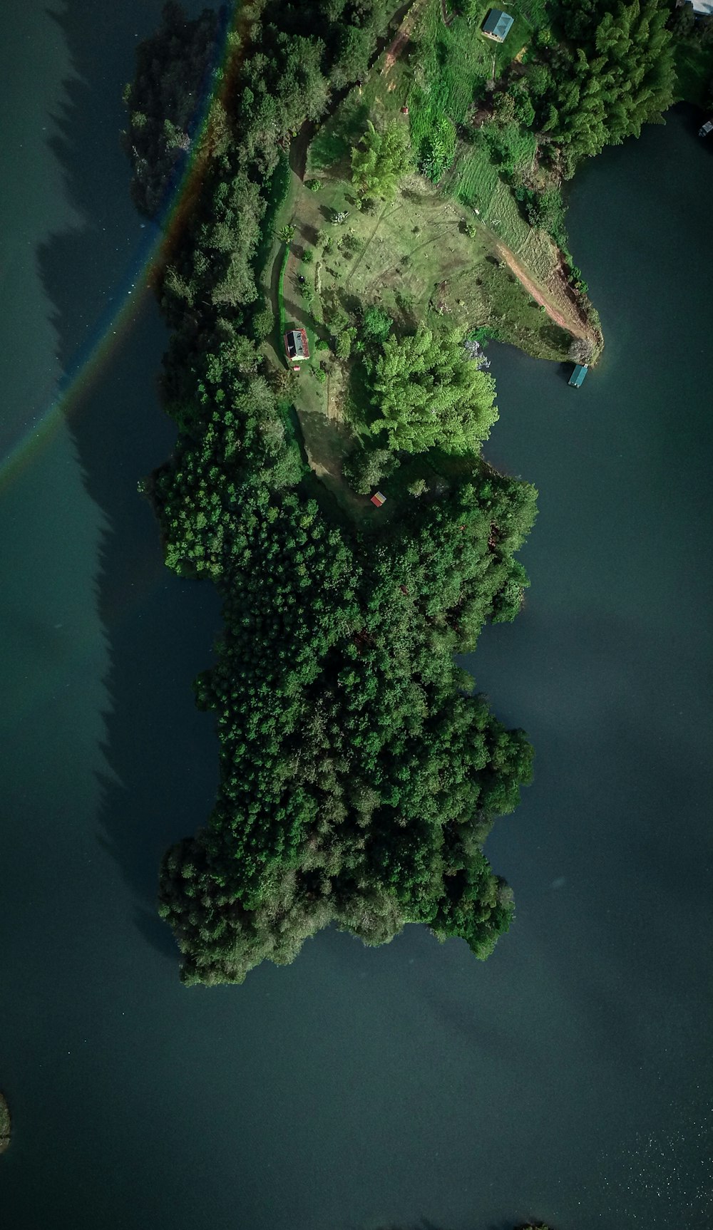 an aerial view of a lake with a rainbow in the sky