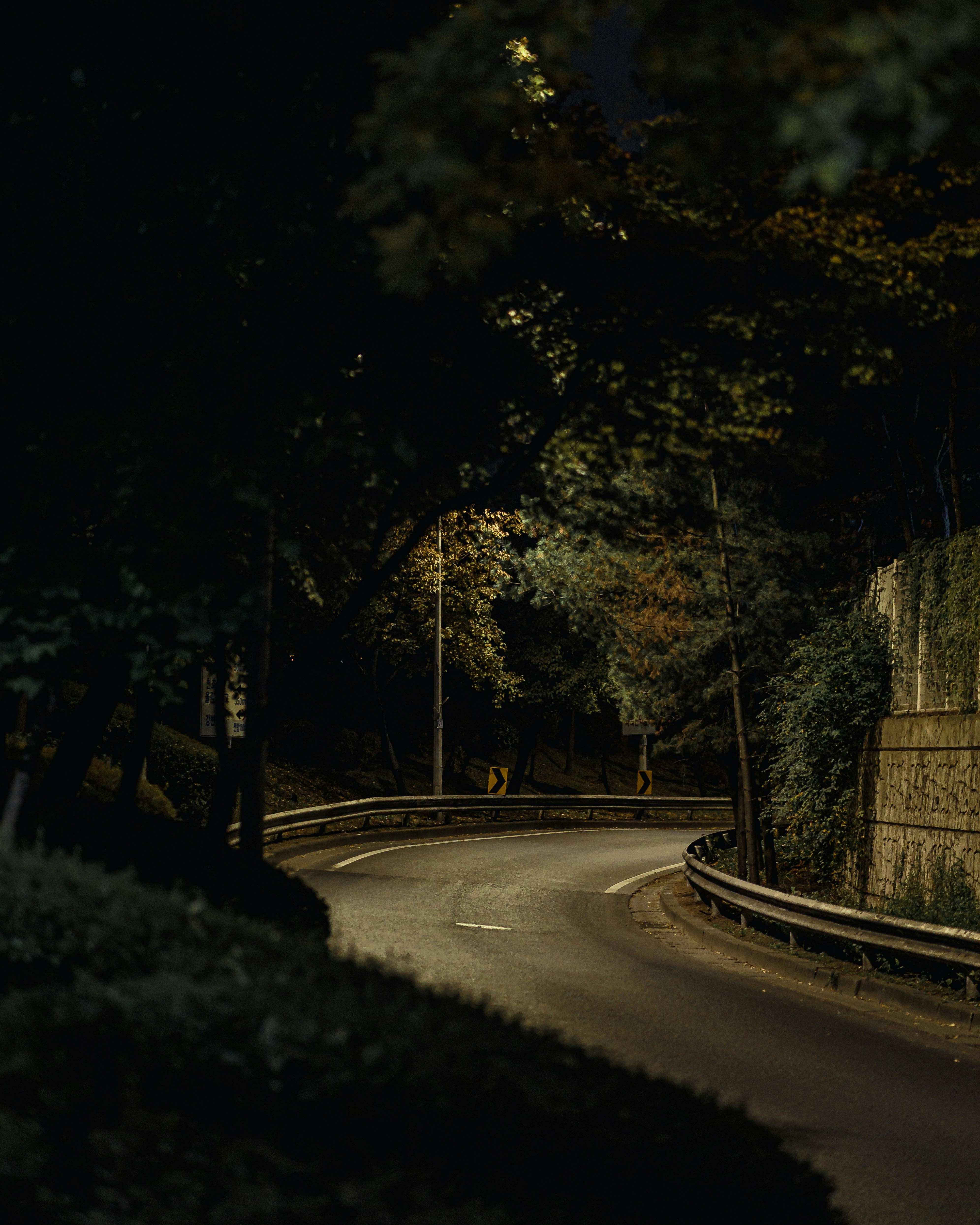 a curved road with a stop sign on the side of it
