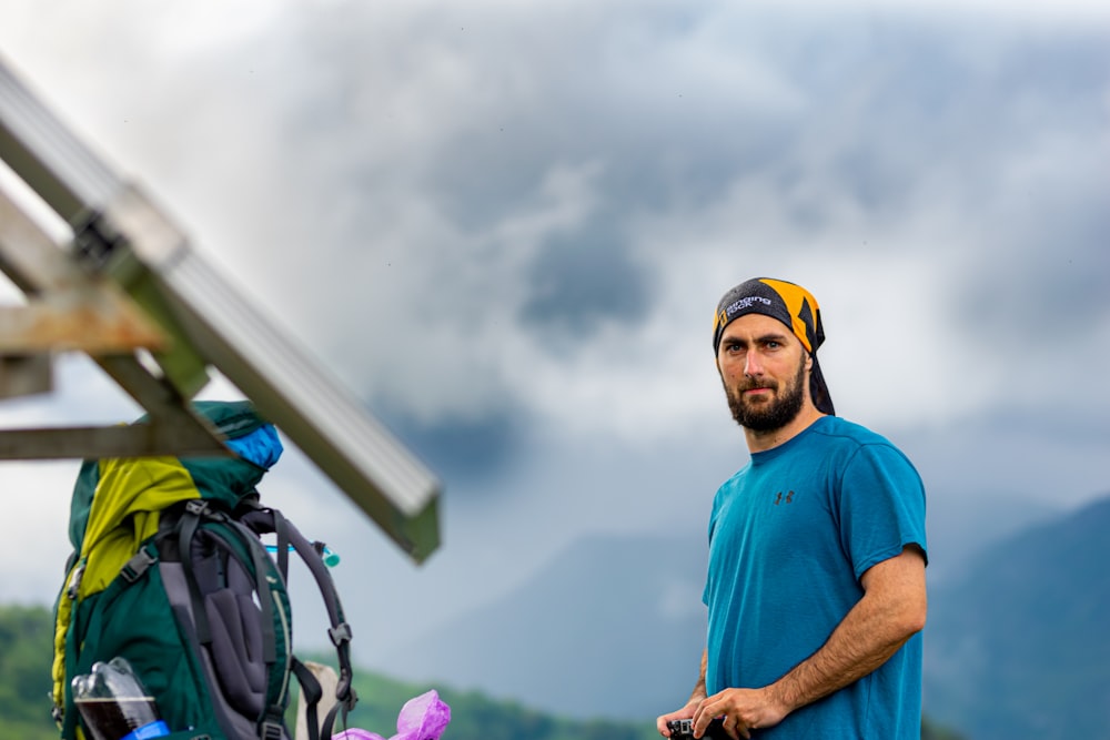 a man in a blue shirt and a backpack