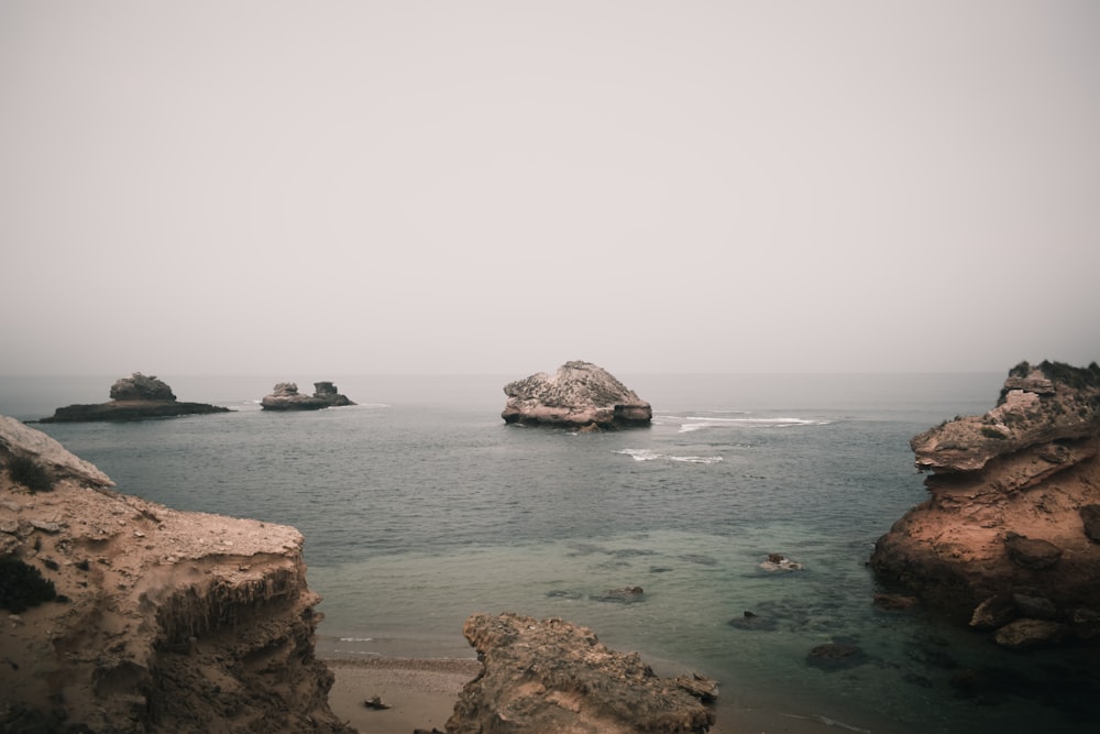 a body of water with rocks in the middle of it