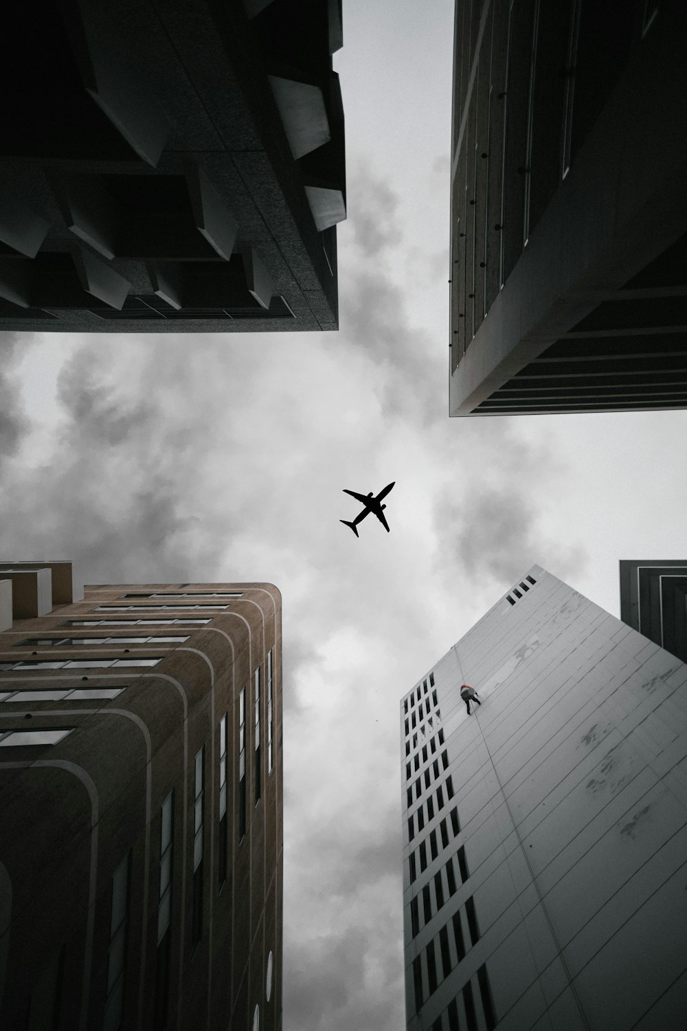 an airplane flying in the sky between two buildings