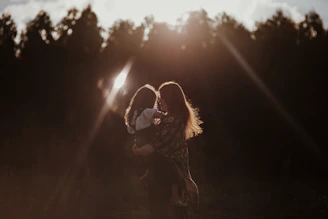 a woman holding a baby in her arms