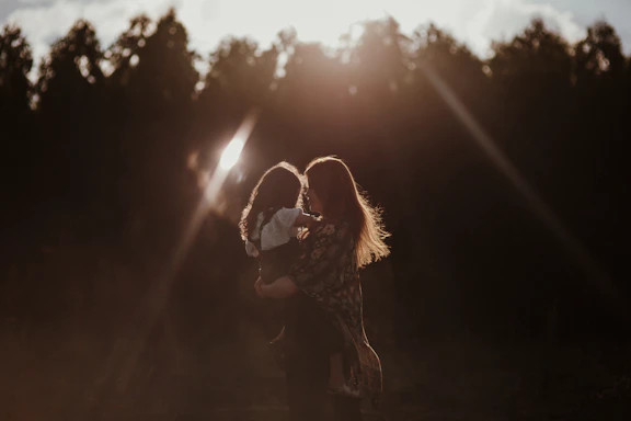 a woman holding a baby in her arms