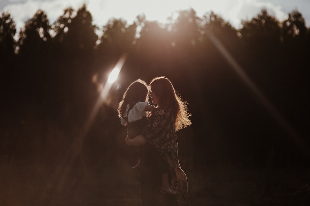 a woman holding a baby in her arms